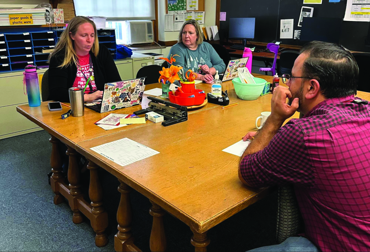 Schedule committee members Emily Shrestha, Erin Mauch and Nalin Needham, all of whom are English teachers, meet in the English Department office Dec. 7.