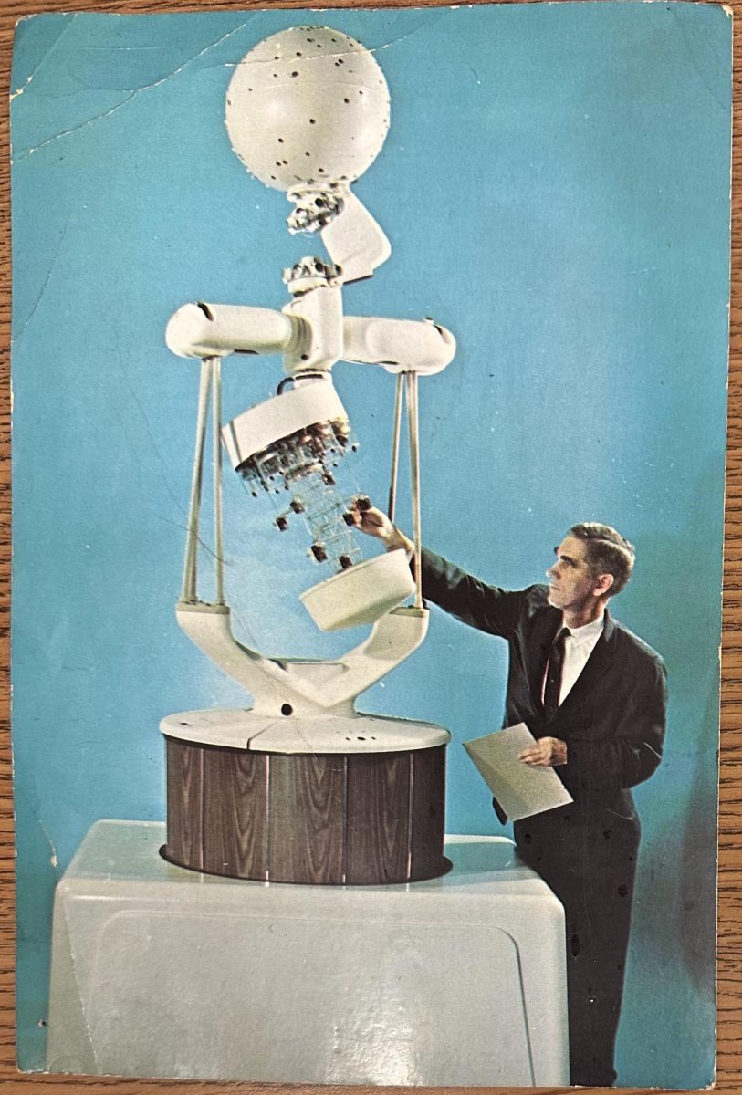 A promotional card from Spitz shows the A4 projector in operation. The card is posted in Planetarium Director Bryan Childs office.