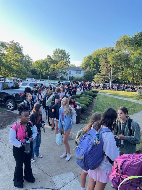 At 8:22 a.m. today, the line of students awaiting security screening at the lower cafeteria entrance extends through the front entrance parking lot and down the Aldersyde Drive sidewalk. 