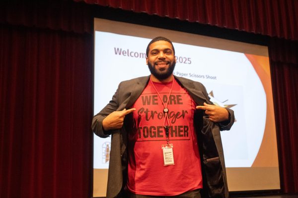 Isaiah Wyatt displays a shirt that expresses his belief in unity during a Jan. 8 assembly in the large auditorium.