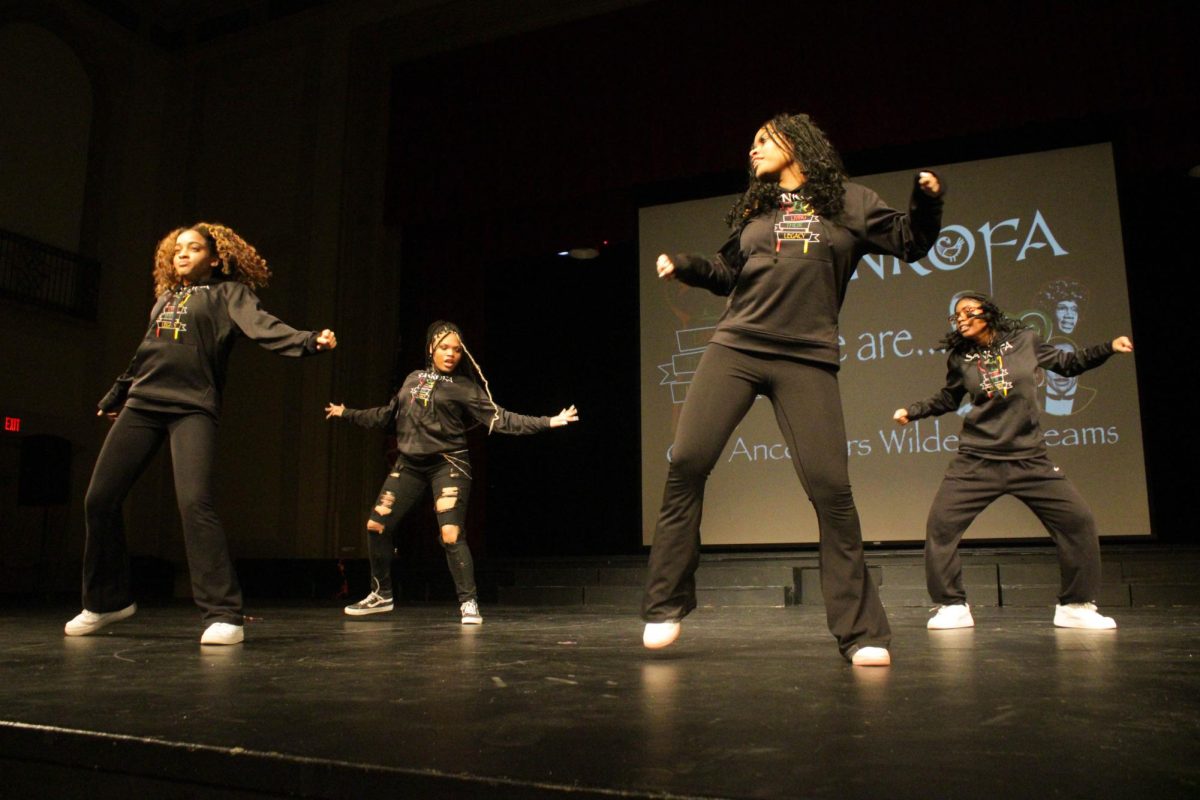 Seniors Miranda Burrell and Brianna Hill and juniors Vijaya Sadler and Victoria Sadler perform a dance to a 1990s and 2000s hip-hop mix during the second preview assembly today in the large auditorium.  