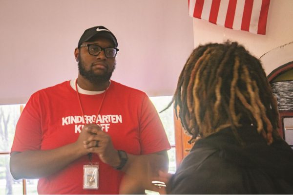 DEI Coordinator William Warren speaks to a student during an American Experience class in Room 251. Warren graduated from the high school in 2007, when the daily schedule was the same as it will be next year.