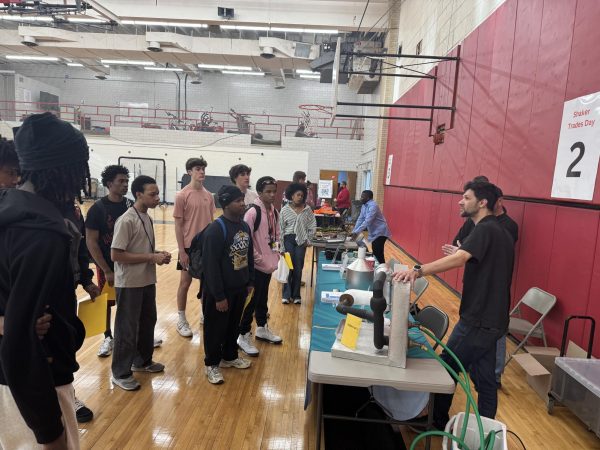 A group of students gathers around the HVAC presentation during Trades Day April 24 in the South Gym.