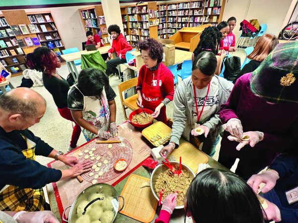 Students and staff gather in the library to share food during a day-long Lunar New Year celebration Jan. 28, supported by the Shaker Schools Foundation. 