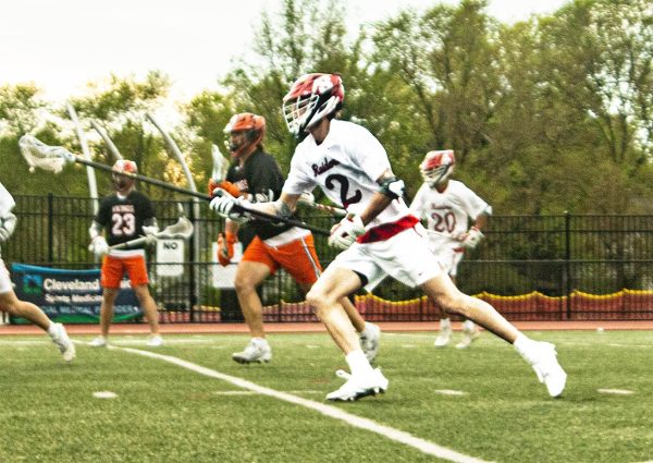 Senior Miles Shelton heads downfield during the Raiders' 10-8 defeat of North Canton Hoover May 13 at Russell H. Rupp Field.