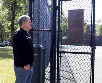Al Slawson looks at the newly placed plaque commemorating his men’s and women’s tennis coaching career Aug. 25 at the SHHS tennis courts.