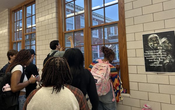 As a first-day tradition, seniors decorate the windows of the second floor "senior hallway" before classes begin. 