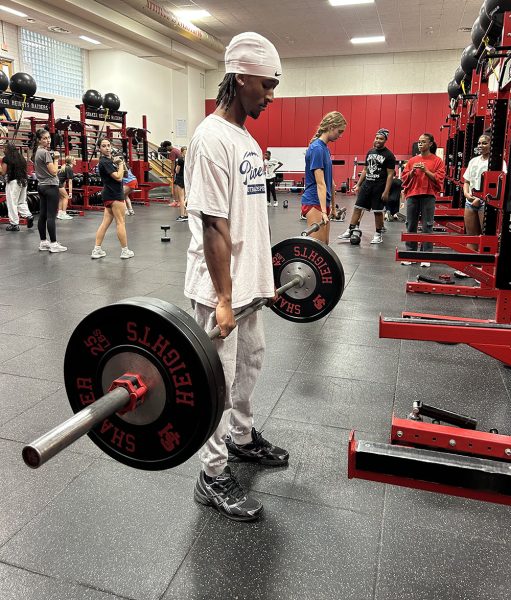 Senior wide receiver Lyndon Chavis executes a deadlift during third period Strength and Conditioning class in the Raider Athletic Center Oct. 22.