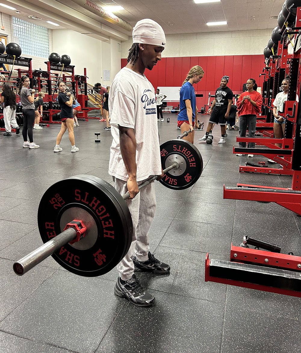 Senior wide receiver Lyndon Chavis executes a deadlift during third period Strength and Conditioning class in the Raider Athletic Center Oct. 22.