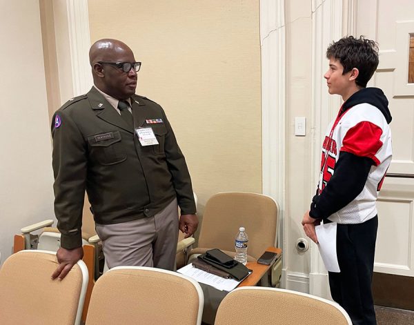 Brigadier General Jeffrey Watkins speaks with Spotlight Reporter Charlie Howell during first period Oct. 10 in the small auditorium. Watkins was among the nine 2025 inductees to the Shaker Schools Foundation's Alumni Hall of Fame. He told Howell that that he wore the same jersey number, 85, while playing football for the Raiders. The inductees addressed an assebmly audience in the large auditorium during second period. 