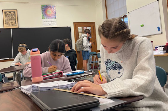 Students work on math during conference period after school Nov. 5 in Room 232. According to a Shakerite survey, making up a test or retaking a test are the most common reasons for attending conferences.