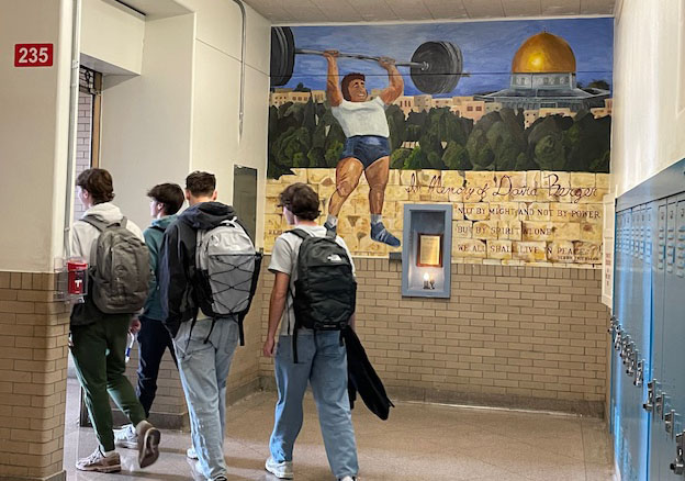  Four students pass the David Berger mural at the end of the 228 hallway after sixth period Nov. 14. Despite being located in a busy part of the high school, the mural and its story are not well known. 