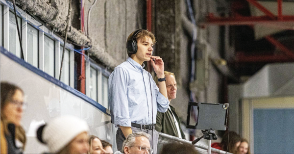 Vaughn Ullom, known as The Voice for his fluent, professional-quality sports commentary, works a Raider hockey game. Ullom graduated last year and is pursuing more broadcast opportunities at Arizona State University.