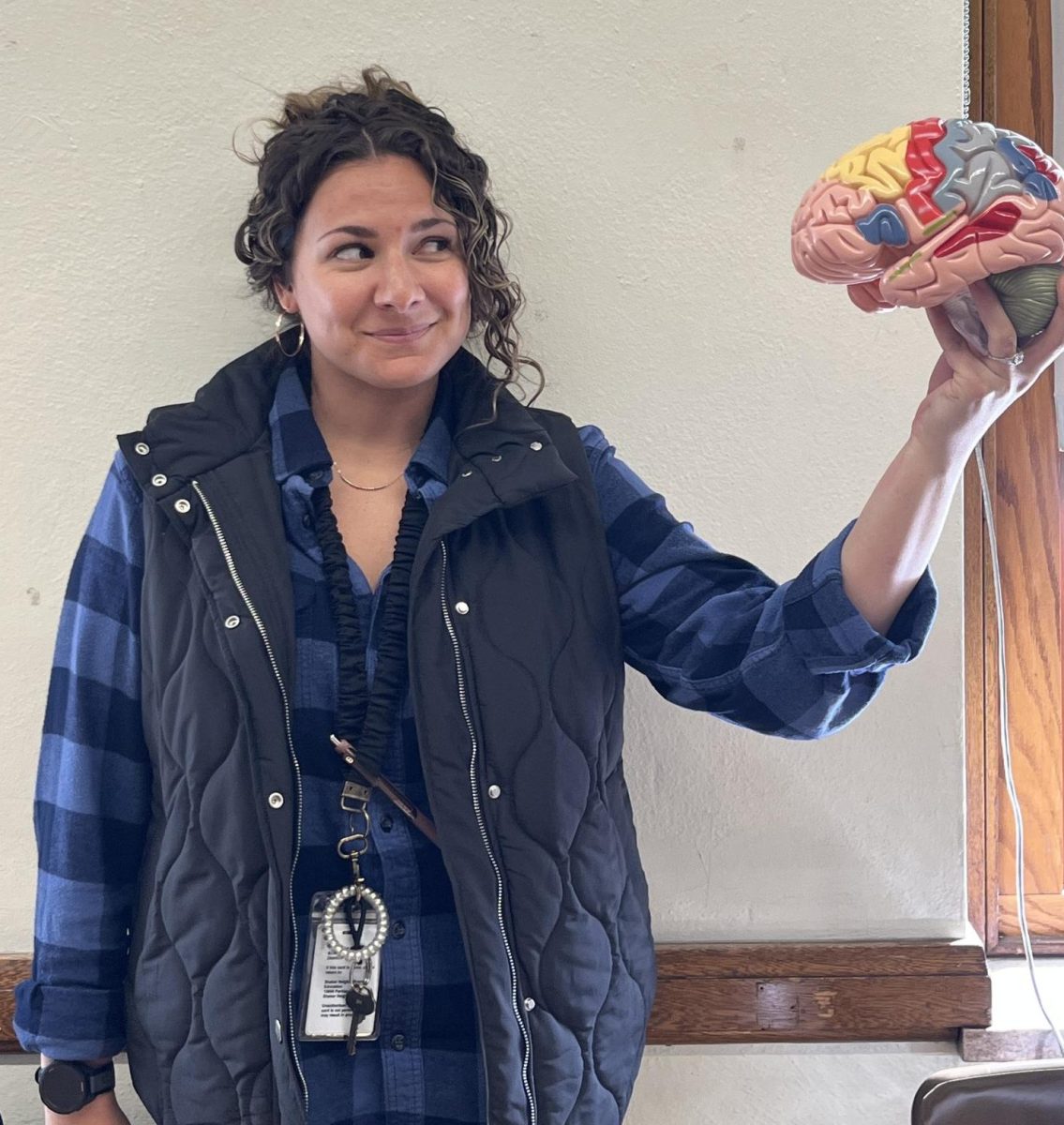 Psychology teacher Victoria Berndt holds a model brain Oct. 20 in Room 222, where she also holds conferences. “I have a large calendar on my bulletin board which I update monthly that reflects which days I am or are not available after school,” Berndt said. 
