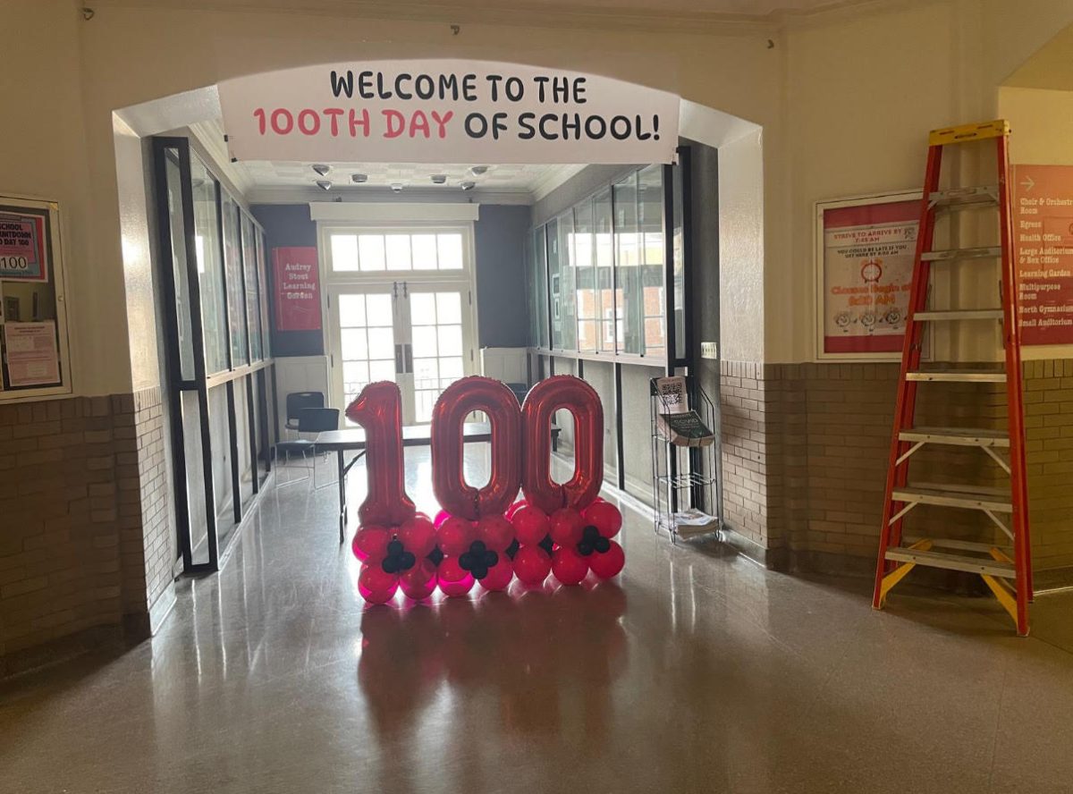 Administrators set up balloons and a banner in the Eli Gallery on President's Day in preparation for celebrating the 100th day of school Feb. 17. 