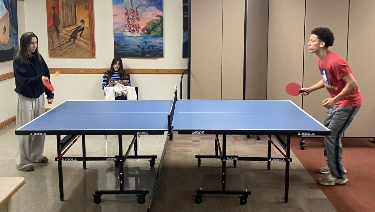 Seniors Mylo Jones and Sloan Gurney play ping-pong in the senior lounge Mar. 9.  Gurney said the new ping-pong and air hockey tables are an intriguing incentive to be in the lounge. "It used to just be a room where the seniors were expected to eat their lunch," she said. "Now I have a reason to actually enjoy the exclusive space."