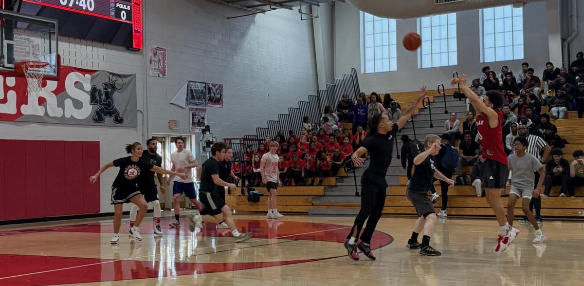 Senior Mylo Jones attempts a deep three-pointer in the annual Student vs. Staff Basketball Game fundraiser on Mar. 13 hosted by Youth Ending Hunger. The Staff beat the Students 26-23. Math Teacher Adam Thomas was happy with the low score. “It was a much slower pace this year, which was good,” he said. Jones was happy to play basketball in front of fans again. “It was crazy, man. It felt really good that all my community came out to come see me play,” he said. Thomas was disappointed in the Students’ performance this year. “The kids didn’t bring it. Their aggression wasn’t there,” he said. Despite the loss, Jones said the game brought the school closer together. “I’m really proud to be a Raider,” he said. Thomas was confident in the Staff’s victory. Said Thomas “we knew it was never a doubt.”