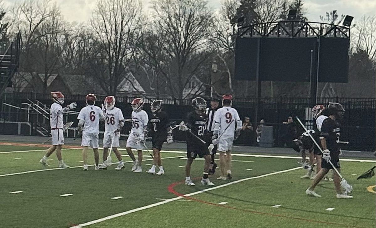 The men's lacrosse team celebrates junior Andrew Mullen's third goal April 2 at Russell H. Rupp Field. Mullen’s goal put the Raiders up 3-1 against University School with two minutes left in the first quarter. The Raiders defeated the Preppers 10-5, led by Mullen's seven goals and two assists. The Raiders have beat University School two out of the last three years. Face-off specialist Andrew Rood, a sophomore, said it was a great feeling to beat a rival. Said Rood, "My boys and I were having the time of our lives beating US."