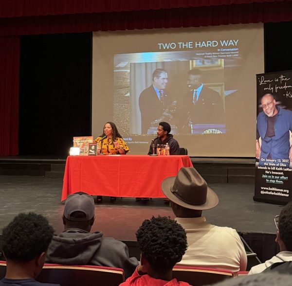 Ayesha Bell Hardaway ('93) moderates a discussion with NFL veteran Desmond Howard and his childhood friend Keith LaMar during an assembly the large auditorium March 30. LaMar called into the assembly from the Ohio State Penitentiary, where is on death row.  