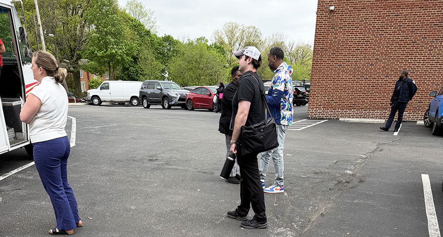 Staff visit the south parking lot to enjoy a teacher appreciation week treat of East Coast Custard while a Shaker Heights Police officer monitors the area May 5. Police remained visible around campus after a phone call to the main office about an armed person outside the building prompted a shelter-in-place order. The order was lifted after police investigation determined no armed individual was present. 