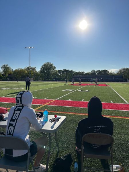 Women's lacrosse managers junior Gabe Moulthrop and senior Evan Weisman work at the game against Lake Catholic at Russel H. Rupp field May 11.